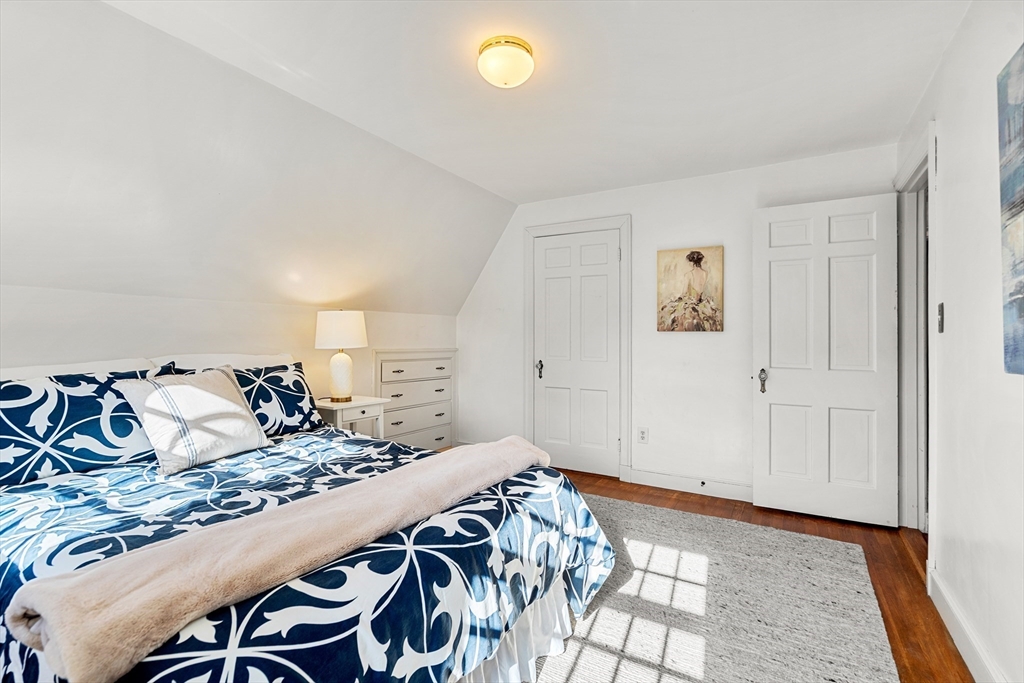 62 Longview Drive Marblehead, MA 01945 - Photo 24 of 42 a bedroom with a bed and a lamp on table