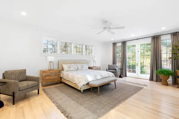 a bedroom with a bed couch and a window