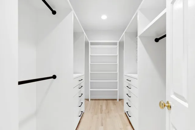 a view of walk in closet with empty racks