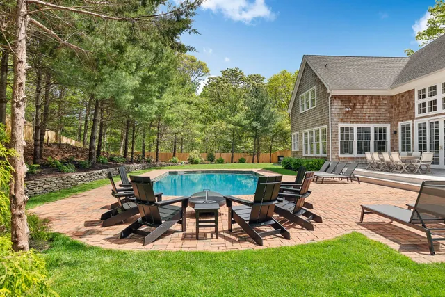 a view of a patio with table and chairs a barbeque with wooden fence