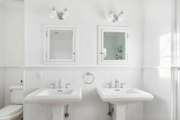 a bathroom with 2 sink and a toilet