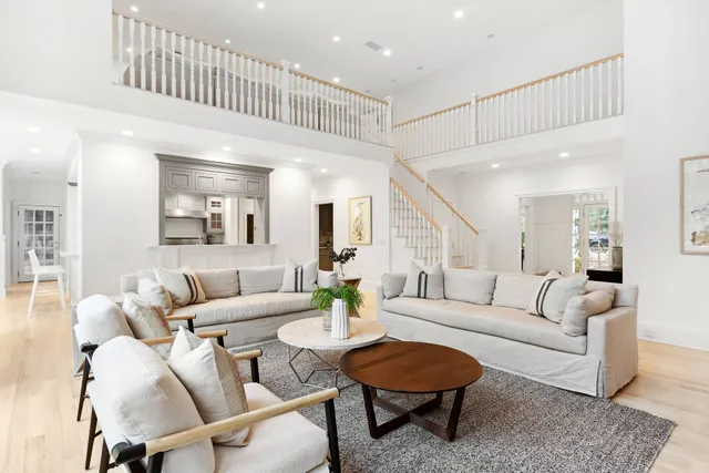 a living room with furniture kitchen view and a table