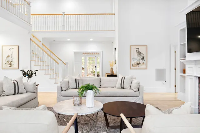 a living room with furniture a flat screen tv and a couch