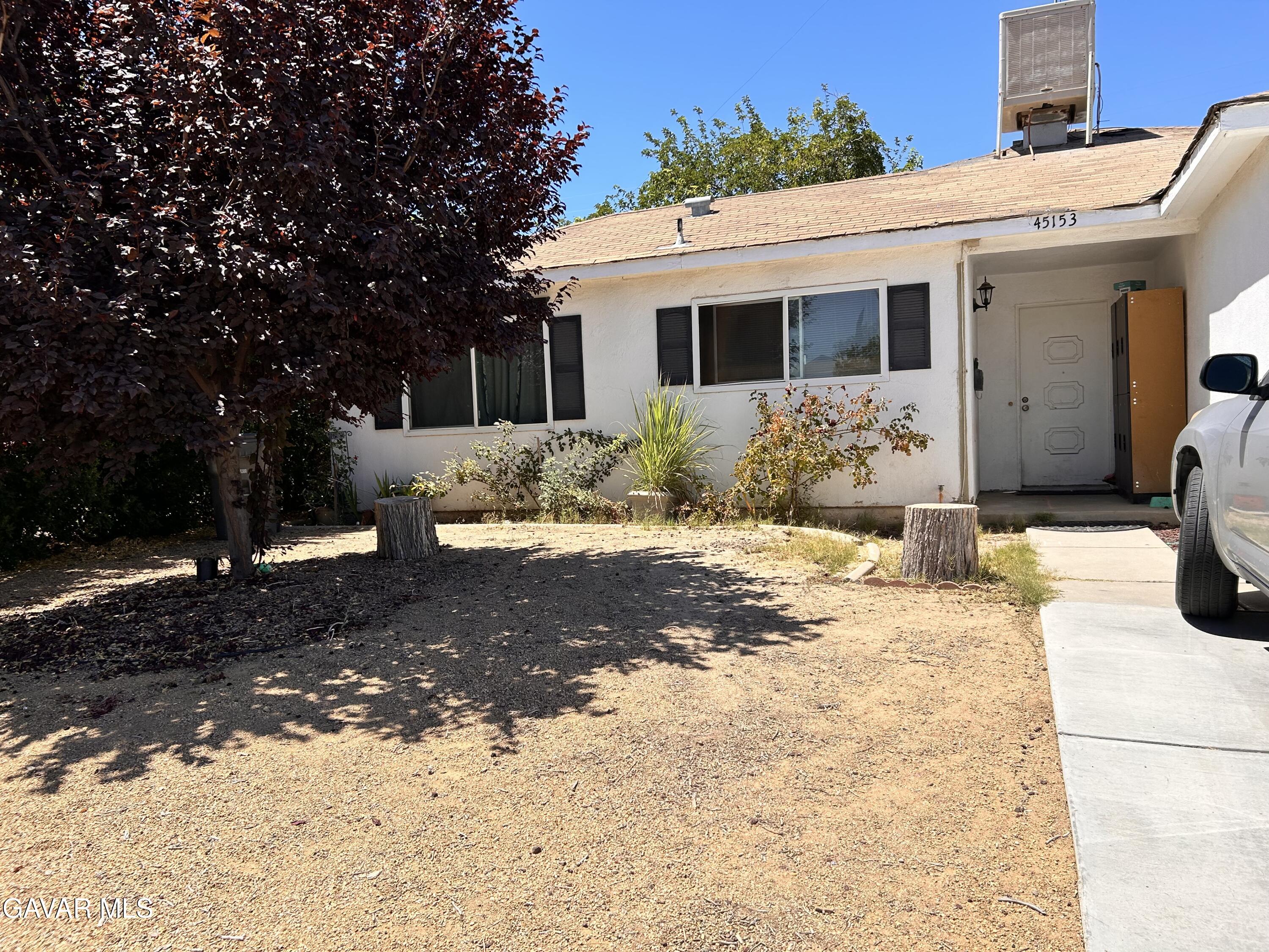 45153 17th Street West Lancaster, CA 93534 - Photo 3 of 3 a front view of a house with a yard covered in snow