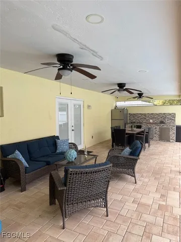 a living room with furniture and a ceiling fan