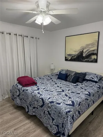 a bed sitting in a bedroom next to a window