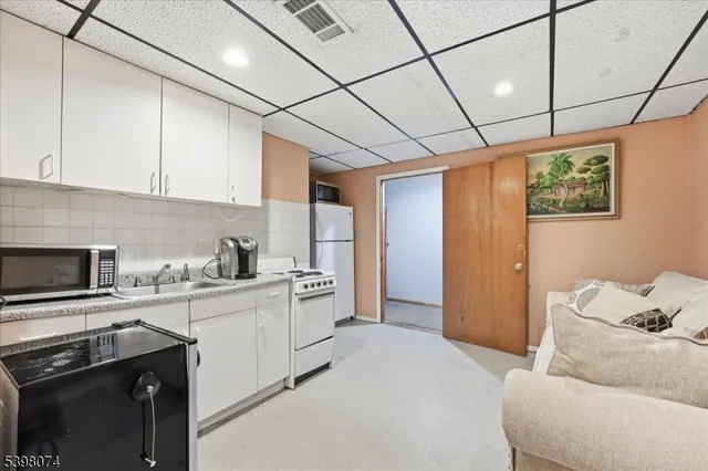a kitchen with stainless steel appliances kitchen island granite countertop a sink stove and refrigerator