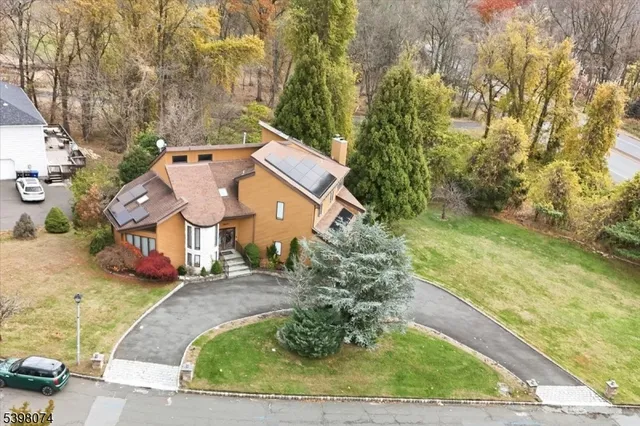 a view of a big house with large trees