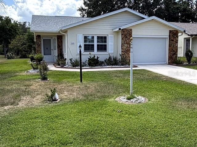 1629 Willow Run Sebring, FL 33872 - Photo 2 of 16 a front view of house with yard and outdoor seating