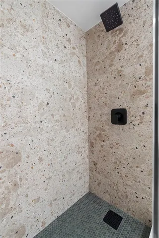 a bathroom with a toilet and a shower