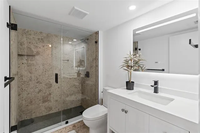 a spacious bathroom with a double vanity sink a mirror and a bathtub