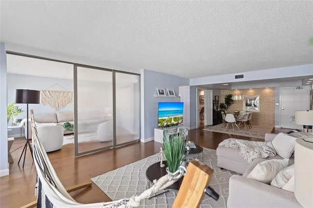 a living room with furniture and a floor to ceiling window
