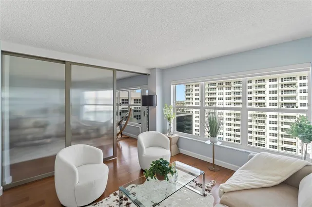 a living room with furniture and a floor to ceiling window