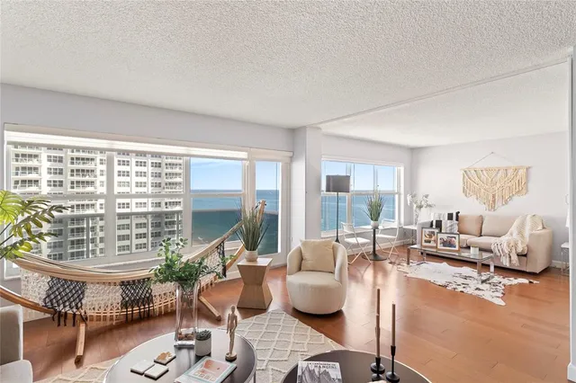 a living room with furniture and a wooden floor
