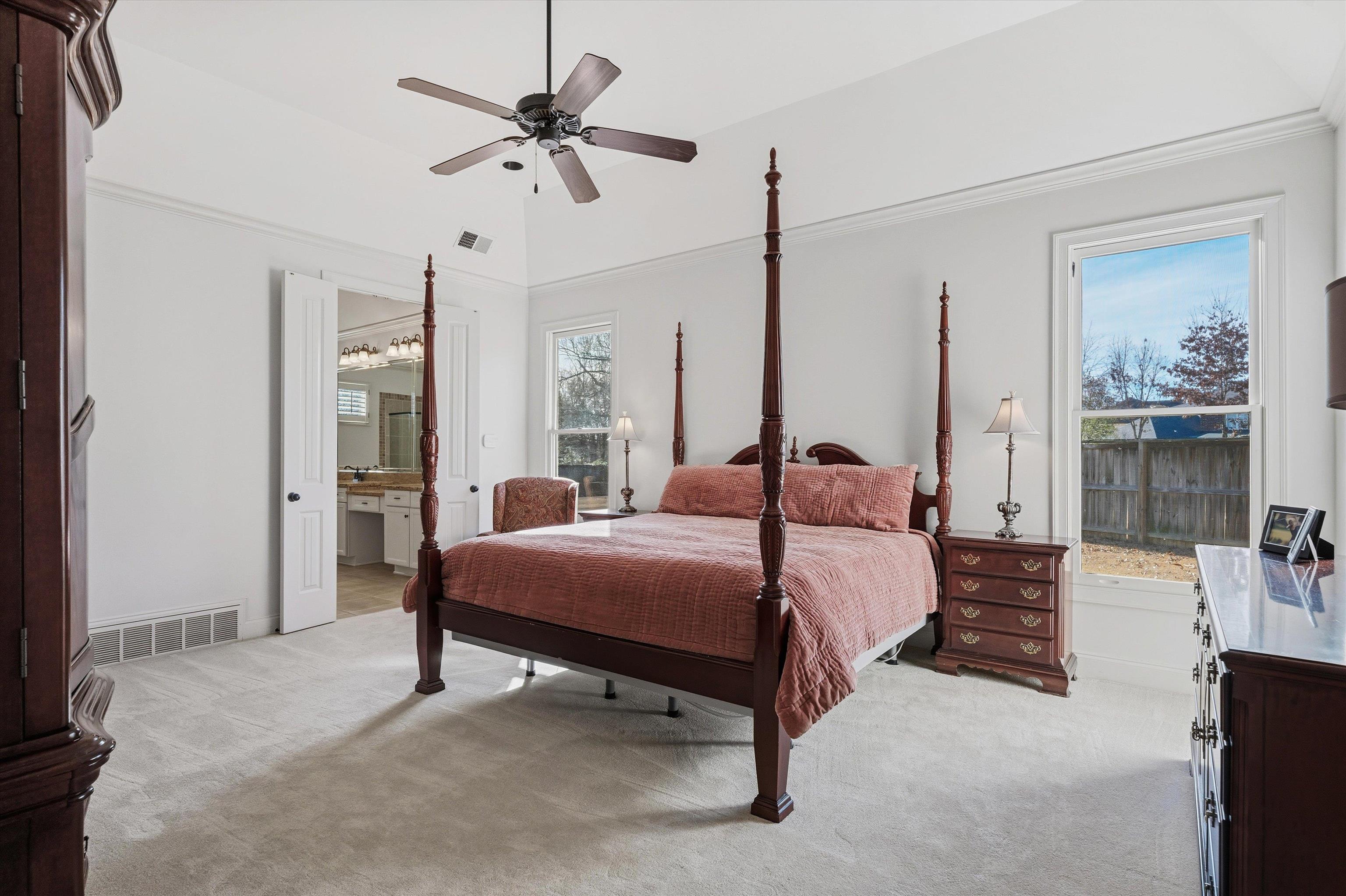 639 Critz Cove Collierville, TN 38017 - Photo 21 of 40 a bedroom with a bed and a chandelier