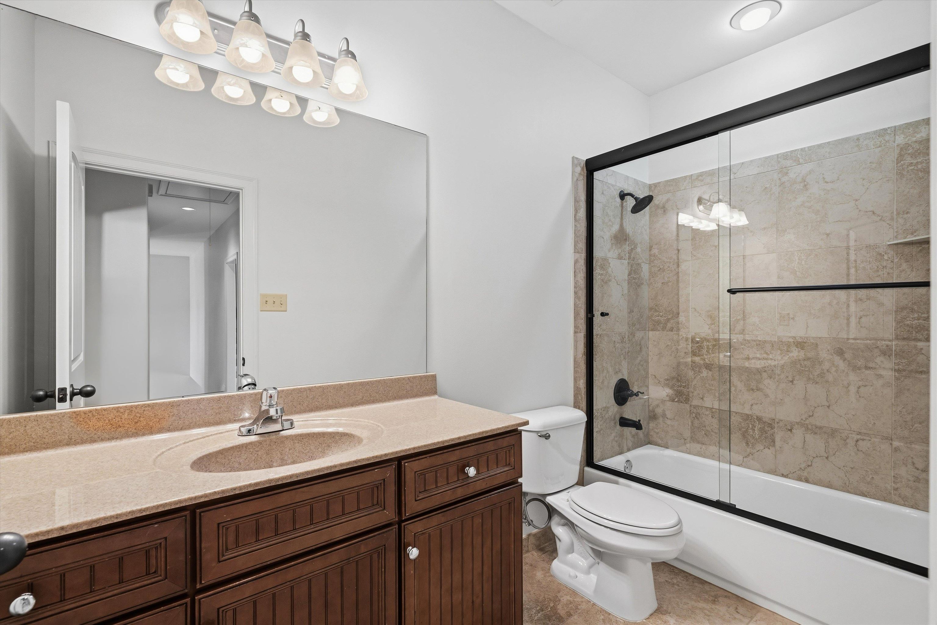 639 Critz Cove Collierville, TN 38017 - Photo 30 of 40 a bathroom with a sink a toilet a mirror and shower