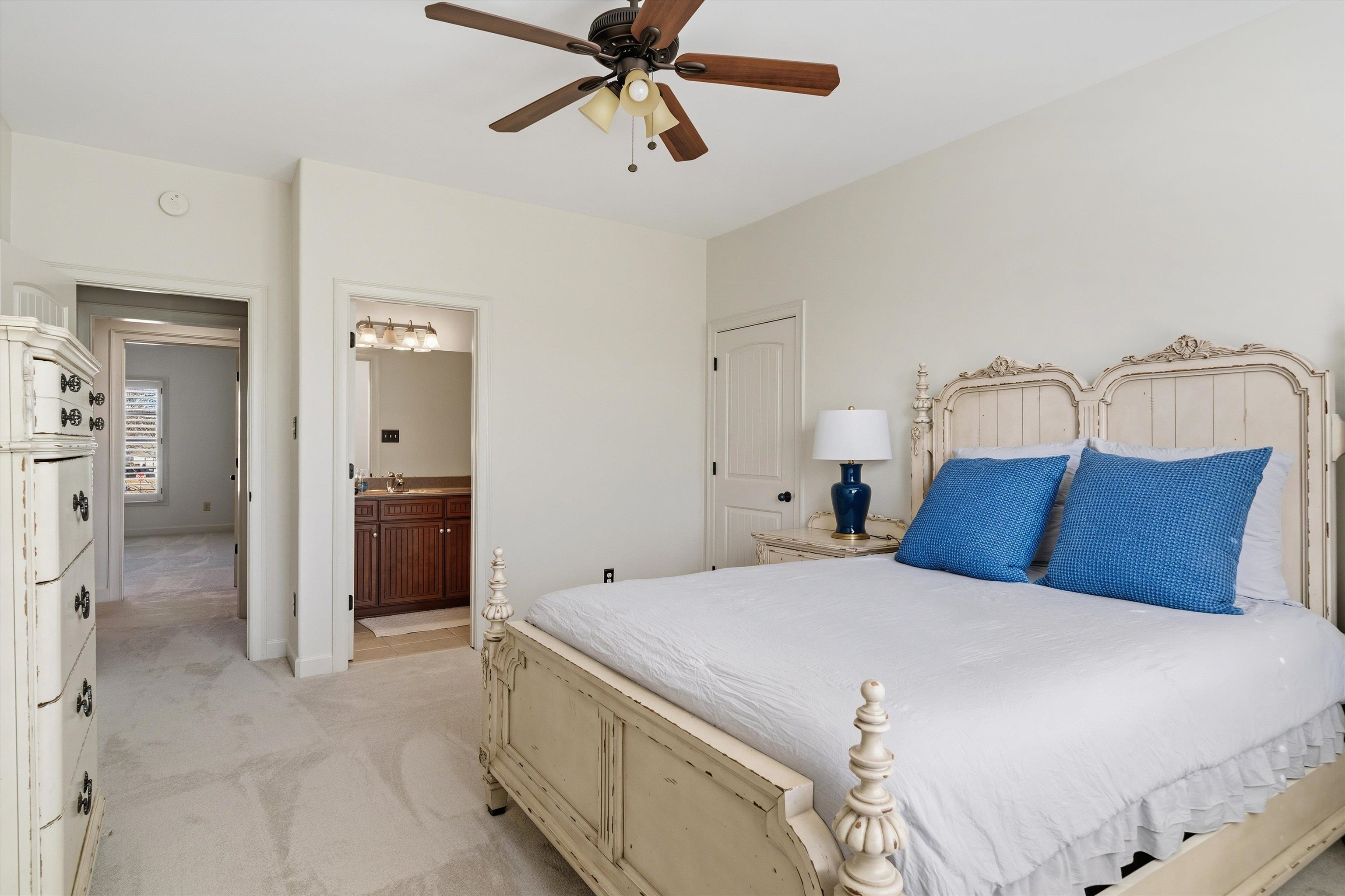 639 Critz Cove Collierville, TN 38017 - Photo 32 of 40 a bedroom with a bed and a chandelier