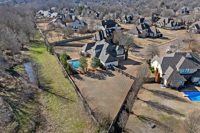 an aerial view of a residential houses with outdoor space