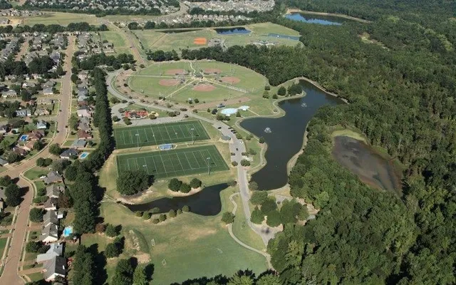 an aerial view of a residential houses with outdoor space