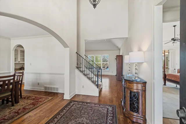 a view of entryway and hall with wooden floor