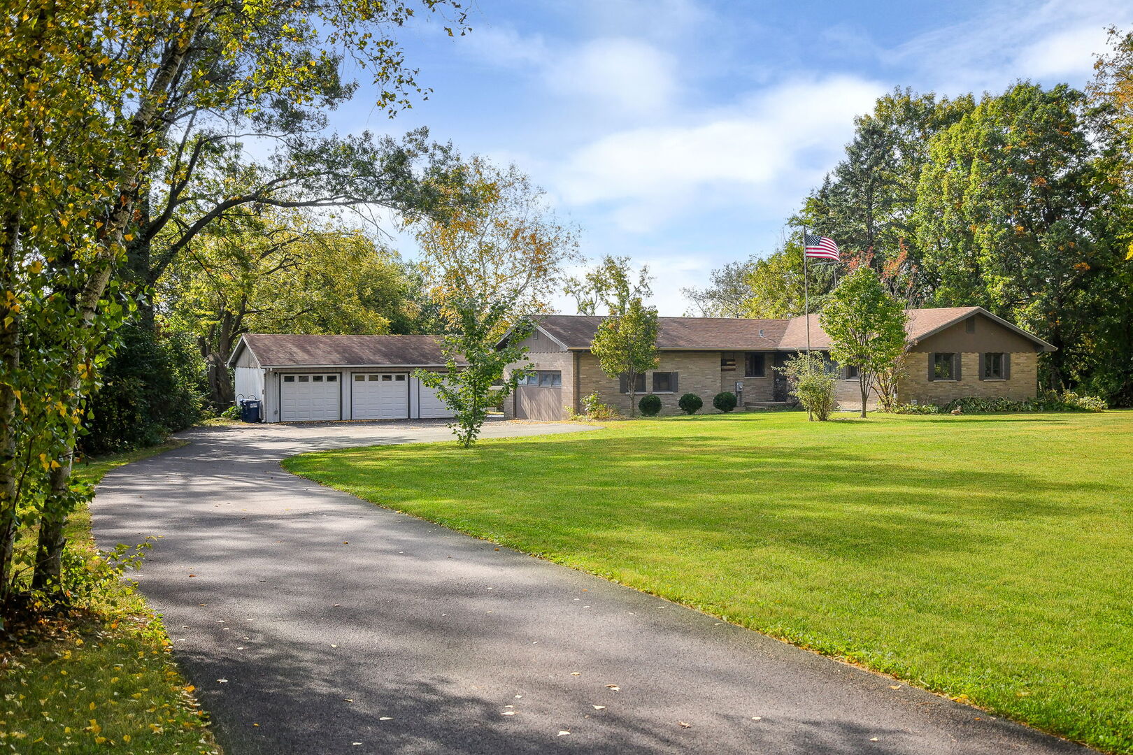 41-w331 Empire Road St. Charles, IL 60175 - Photo 23 of 25 a front view of a house with garden and trees