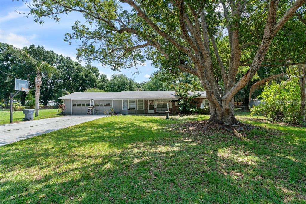216 Pinehurst Drive Auburndale, FL 33823 - Photo 1 of 1 a front view of a house with a garden