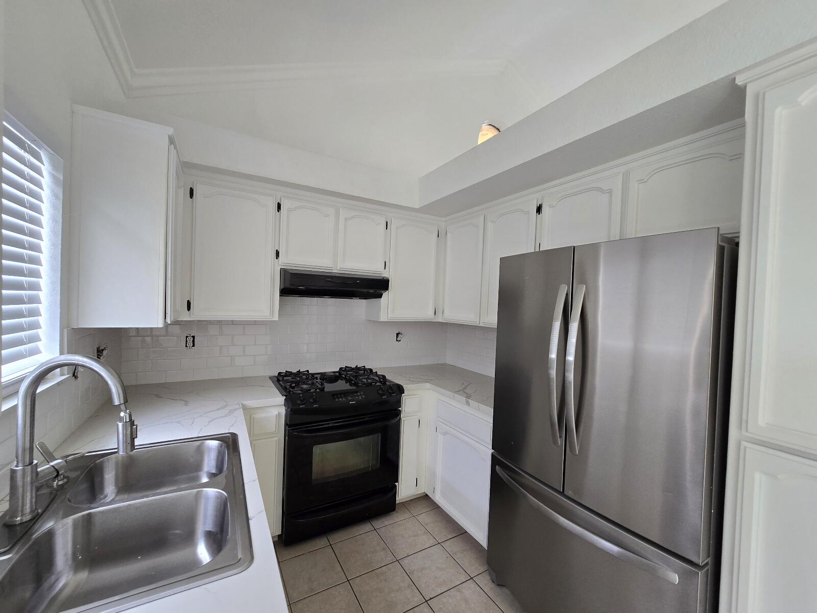 454 Alamine Drive Redding, CA 96003 - Photo 11 of 28 a kitchen with stainless steel appliances granite countertop a refrigerator sink and stove