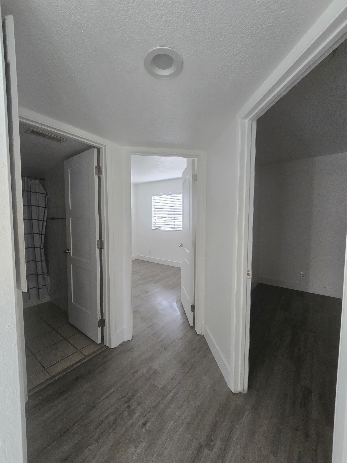 454 Alamine Drive Redding, CA 96003 - Photo 14 of 28 an empty room with wooden floor closet and windows