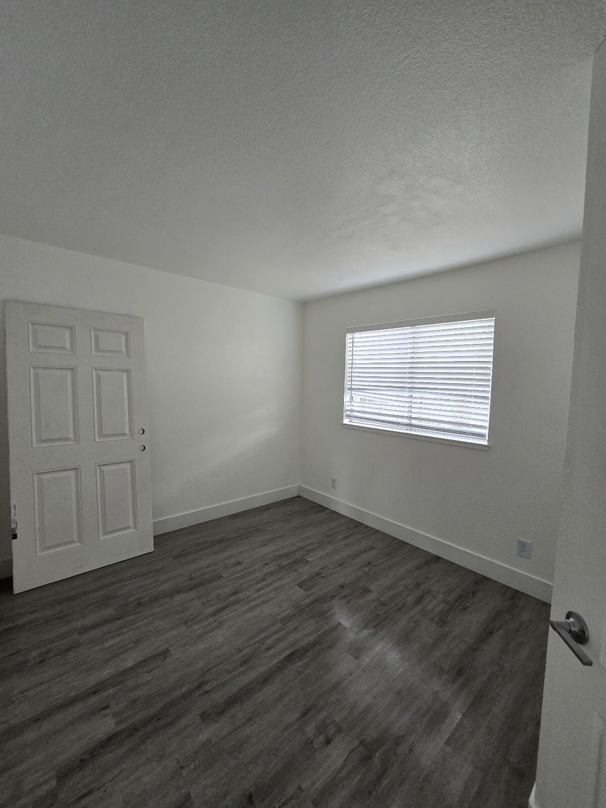 454 Alamine Drive Redding, CA 96003 - Photo 15 of 28 a view of an empty room with wooden floor and a window