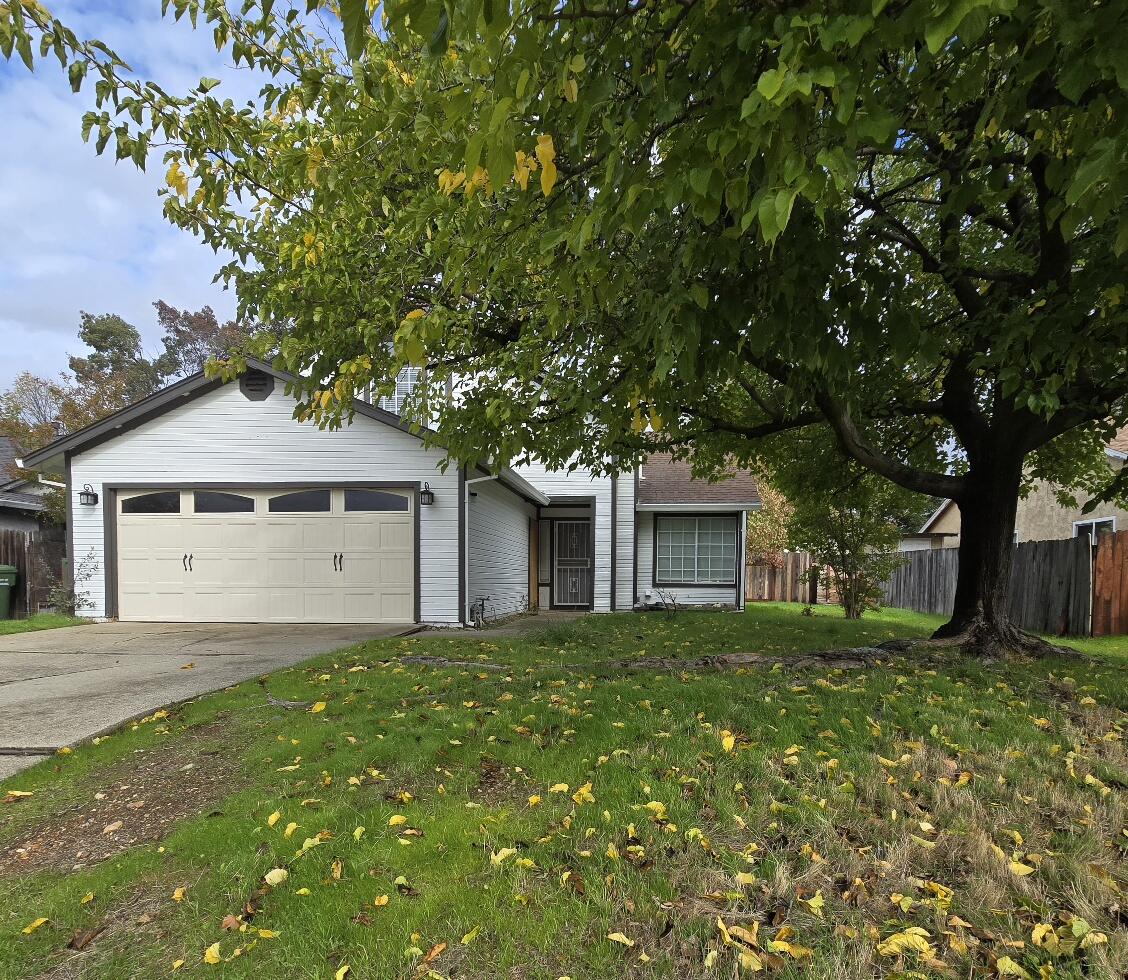 454 Alamine Drive Redding, CA 96003 - Photo 3 of 28 a front view of a house with a garden