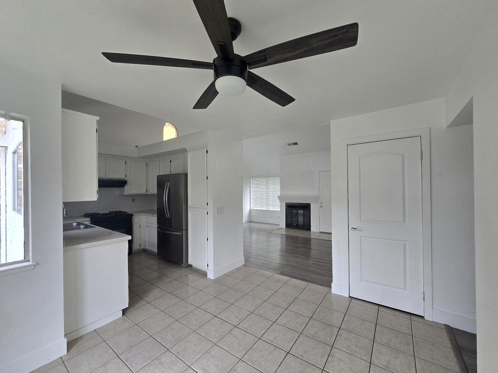 454 Alamine Drive Redding, CA 96003 - Photo 9 of 28 a view of a kitchen with a sink and dishwasher refrigerator a kitchen island