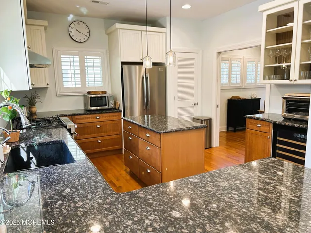 a kitchen with a refrigerator and a stove top oven
