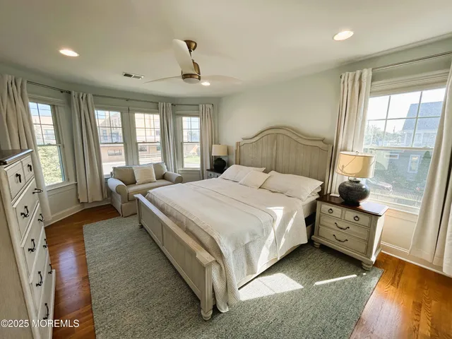 a bedroom with a bed couch and a window