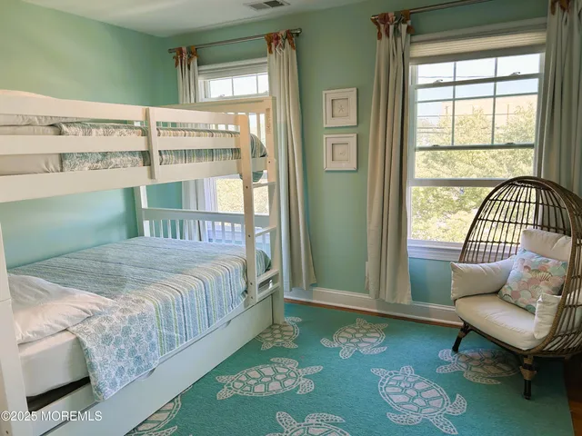 a bedroom with a bed window and a table