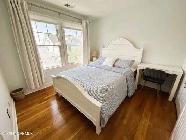 a bathroom with a granite countertop sink toilet and mirror