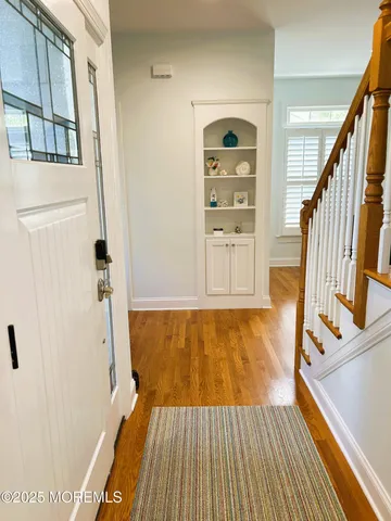 a view of a room with wooden floor and staircase