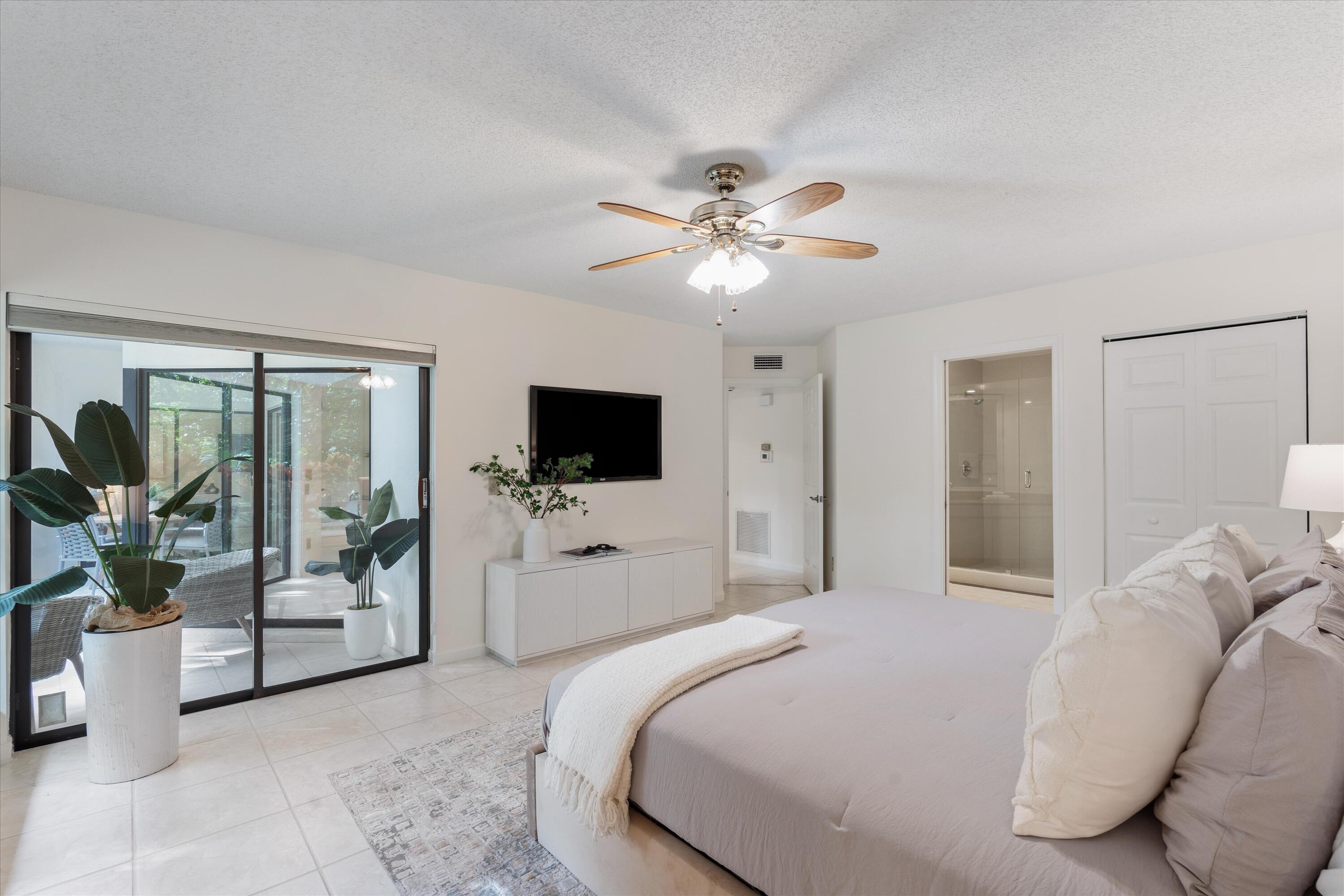 5620 Coach House Circle, Unit D Boca Raton, FL 33486 - Photo 14 of 27 Primary Bedroom with Patio View