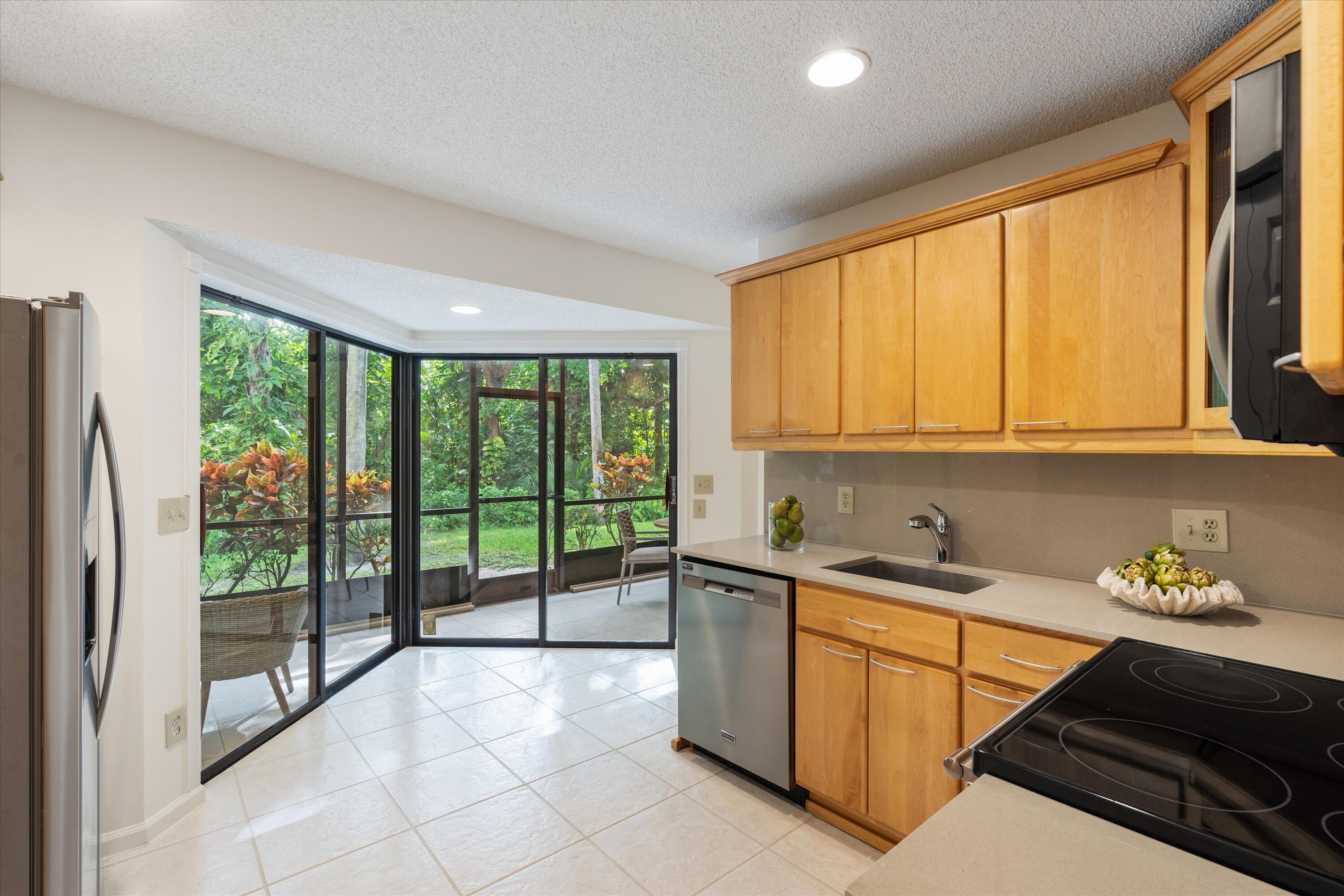5620 Coach House Circle, Unit D Boca Raton, FL 33486 - Photo 22 of 27 Kitchen with view to patio
