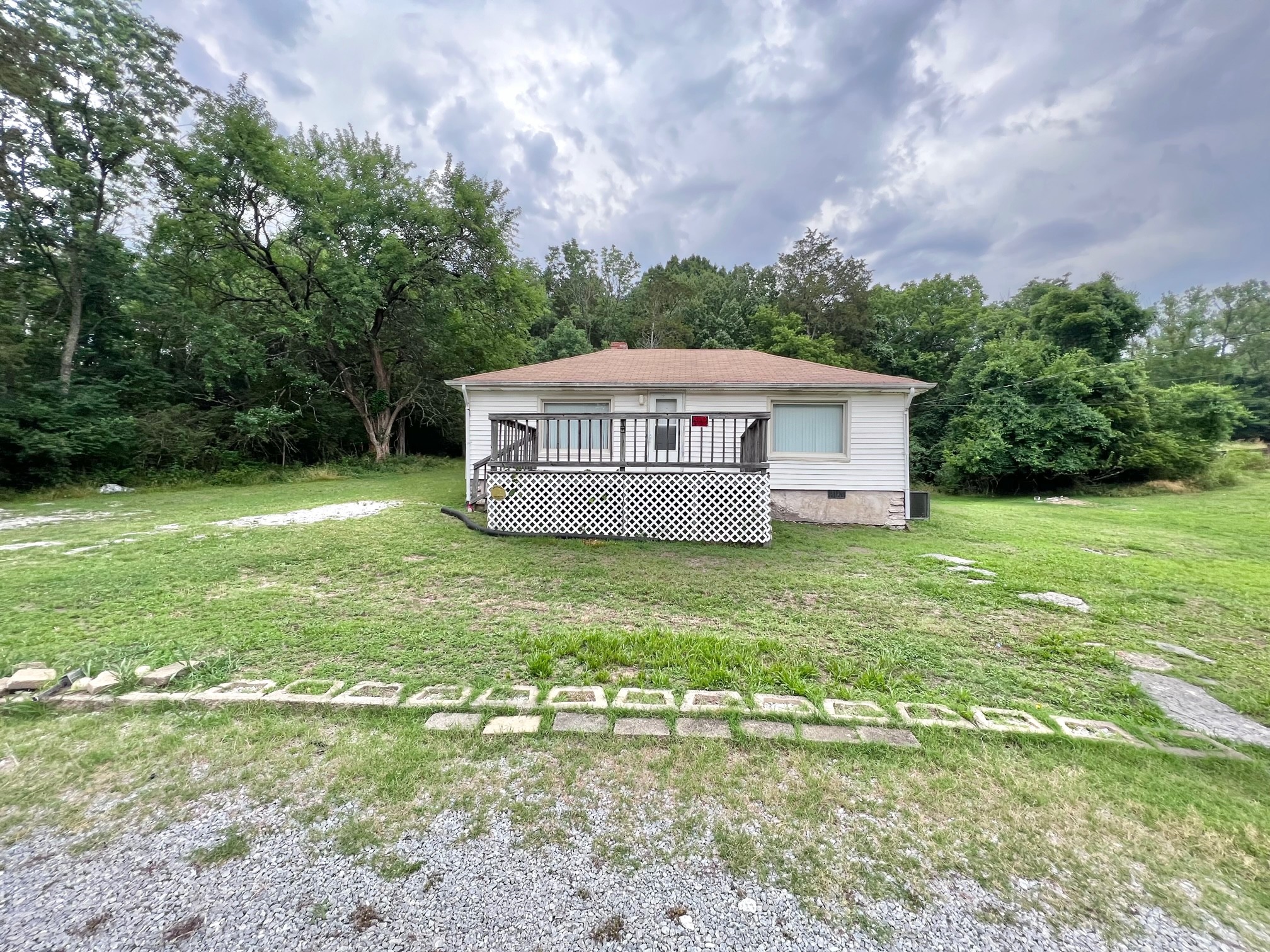 a view of a house with a yard and sitting area