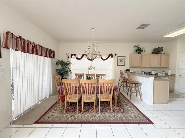 a view of a dining room with furniture and a window