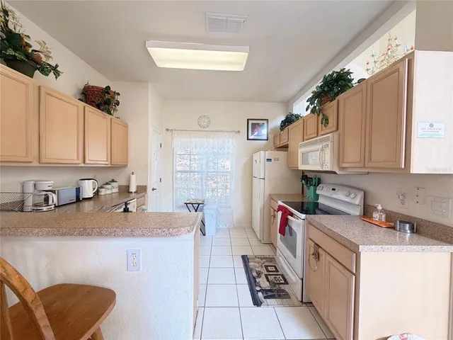 a kitchen with a sink cabinets and window