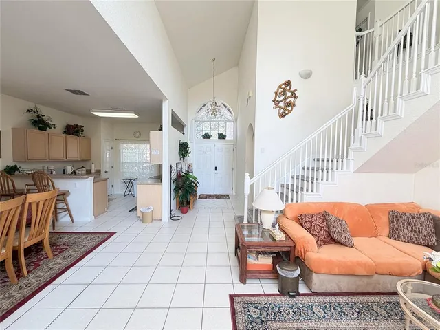 a bedroom with a large bed and a mirror on dresser