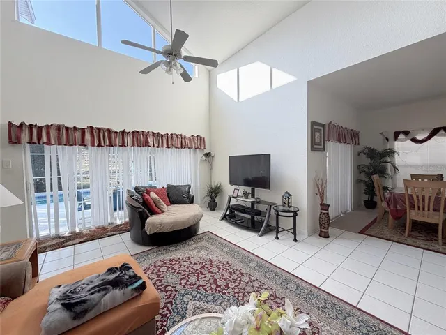 a spacious bedroom with a large bed and a chandelier