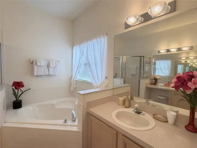 a bathroom with a granite countertop sink a mirror and vanity