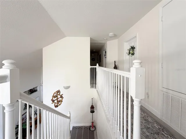 a bedroom with a bed and painting on the wall