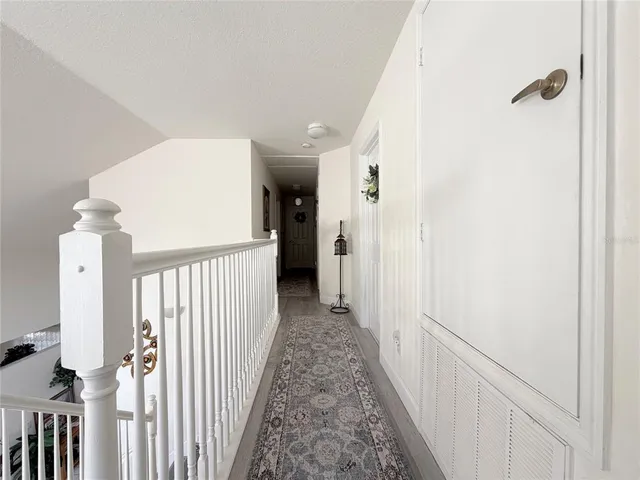 a bedroom with a bed and a lamp on dresser