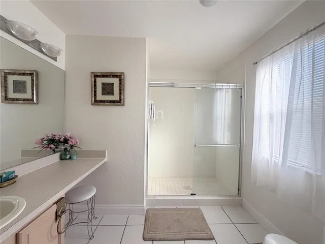 a front view of a house with a garden and tree