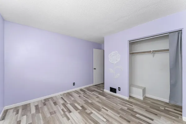 a view of a livingroom with an empty space and wooden floor