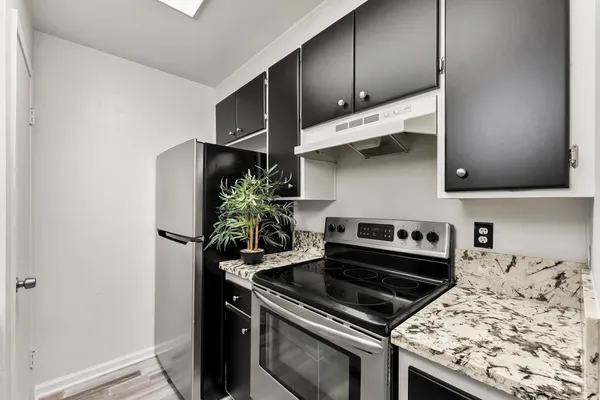 a kitchen with a stove and a refrigerator