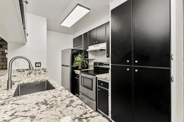 a kitchen with a refrigerator and a sink
